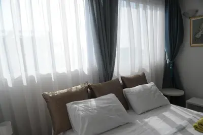 a bedroom with a bed with pillows and a window at El Angel by Ntinos in Kremasti