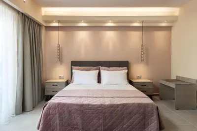a bedroom with a large bed with two night stands at Lampraki Luxury Apartments in Rhodes Town
