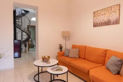 a living room with an orange couch and a table at Anna's house in Rhodes Town