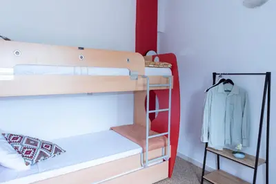 a bunk bed with a ladder next to a closet at Anna's house in Rhodes Town