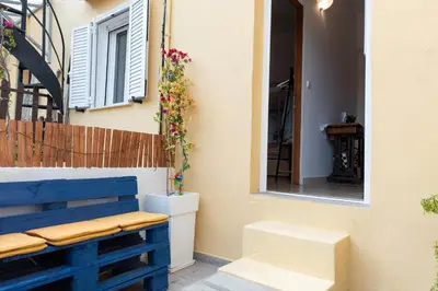 a blue bench in front of a building with a window at Anna's house in Rhodes Town