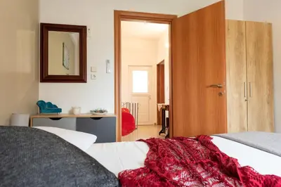 a bedroom with a bed with a red blanket at Anna's house in Rhodes Town