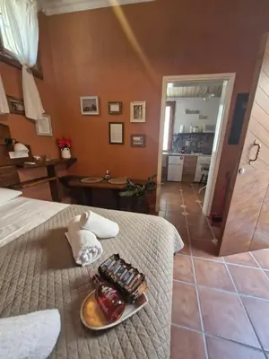 a hotel room with a plate of food on a bed at Tango Suites in Rhodes Town