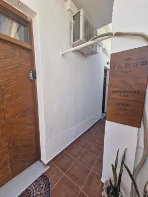 a hallway of a house with a door and a plant at Tango Suites in Rhodes Town