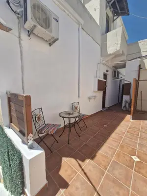 a patio with chairs and a table on a building at Tango Suites in Rhodes Town