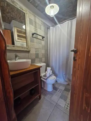 a bathroom with a sink and a toilet and a mirror at Tango Suites in Rhodes Town