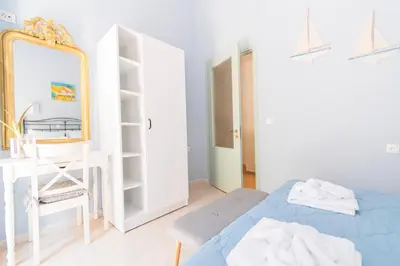 a bedroom with a bed and a mirror and a desk at Arsanas in Symi