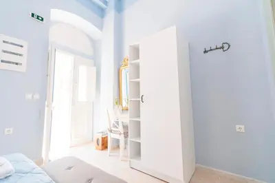 a white room with a door to a bedroom at Arsanas in Symi
