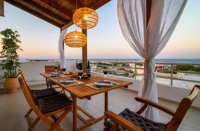 a dining room with a table and chairs at Harama House - Seaview City Apt. in Rhodes Town
