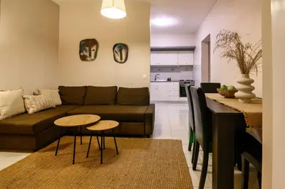 a living room with a couch and a table at Harama House - Seaview City Apt. in Rhodes Town