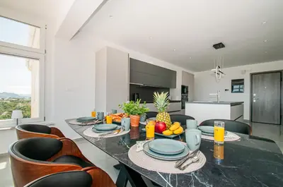 a dining room with a table with fruit on it at Agnanti Sea View Villa in Koskinou