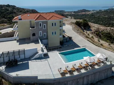 an aerial view of a house with a swimming pool at Agnanti Sea View Villa in Koskinou