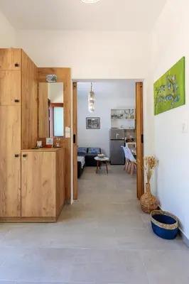 a living room with a kitchen and a dining room at Bluebell House Halki in Halki