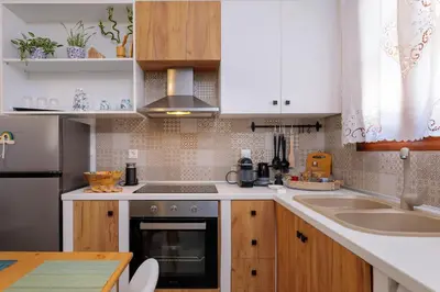 a kitchen with a sink and a stove top oven at Bluebell House Halki in Halki