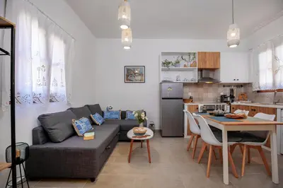 a living room with a couch and a table at Bluebell House Halki in Halki