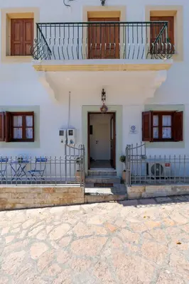 a building with a staircase and a balcony at Bluebell House Halki in Halki