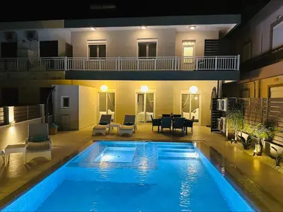 a large swimming pool in the middle of a house at Flev's Luxury House with pool in Kremasti