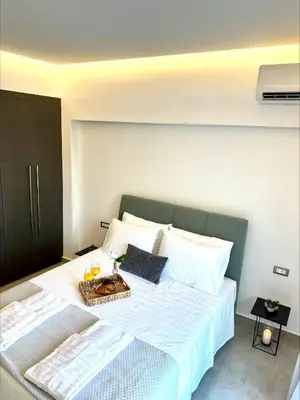a bedroom with a bed with a tray of food on it at Flev's Luxury House with pool in Kremasti