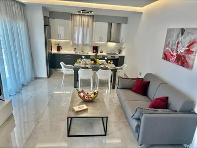 a living room with a couch and a table at Flev's Luxury House with pool in Kremasti