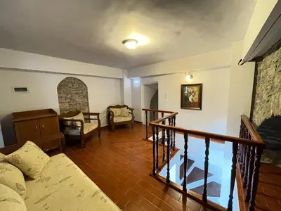 a living room with a couch and a staircase at Anamar Symi Residences in Symi