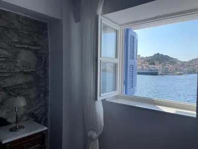 a window in a room with a view of the water at Anamar Symi Residences in Symi