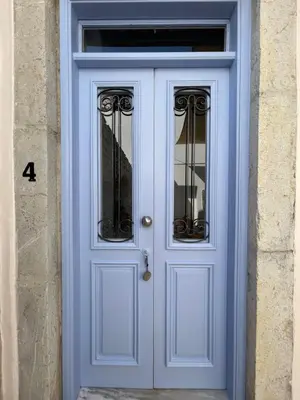 a blue door on a building with the number four at Anamar Symi Residences in Symi