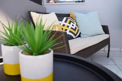 a living room with a couch and a table with plants at Stamatina's Luxury Penthouse in Pastida Rhodes in Pastida
