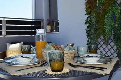 a table with plates of food and drinks on it at Stamatina's Luxury Penthouse in Pastida Rhodes in Pastida