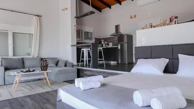 a bedroom with a large bed and a couch at Blue Heaven Kerami in Archangelos