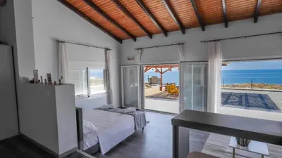 a bedroom with a bed and a view of the ocean at Blue Heaven Kerami in Archangelos