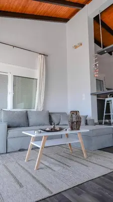 a living room with a couch and a coffee table at Blue Heaven Kerami in Archangelos