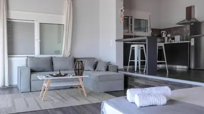 a living room with a couch and a table at Blue Heaven Kerami in Archangelos