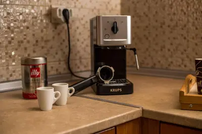 two coffee cups sitting on a counter with a coffee maker at Captain Chris Villa in Afantou