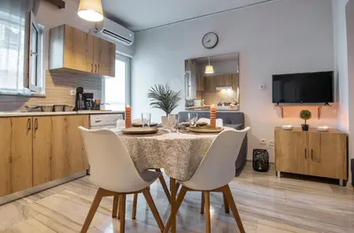 a kitchen and dining room with a table and chairs at Anali Apartment in Ixia