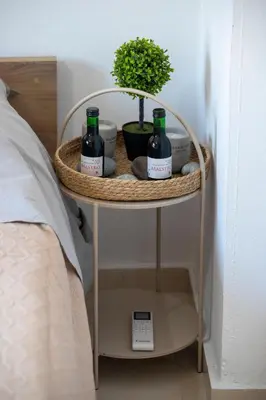 a table with two bottles of wine on it next to a bed at Anali Apartment in Ixia