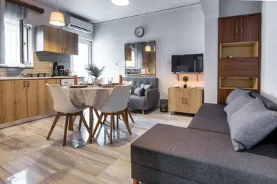 a living room and kitchen with a table and chairs at Anali Apartment in Ixia