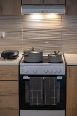 two pots sitting on top of a stove in a kitchen at Anali Apartment in Ixia