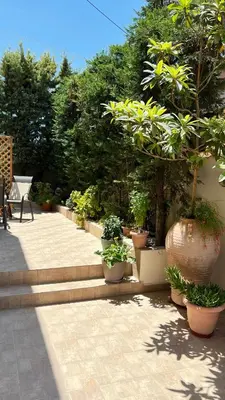 a group of potted plants sitting on a patio at Haplotēs Rhodes Studio in Koskinou