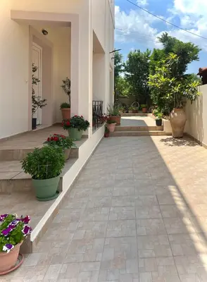 a courtyard of a house with potted plants at Haplotēs Rhodes Studio in Koskinou