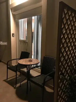 a table and chairs in a room with a window at Haplotēs Rhodes Studio in Koskinou