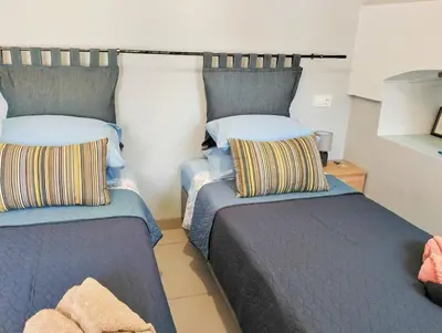 two beds sitting next to each other in a room at The Mill House George in Symi