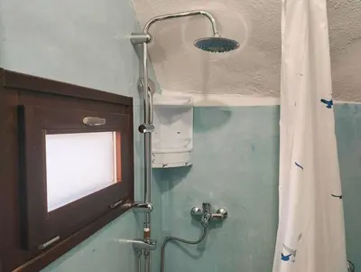 a shower in a bathroom with a shower curtain at The Mill House George in Symi