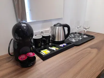 a tray with a coffee maker and glasses on a table at Elite Centre in Rhodes Town
