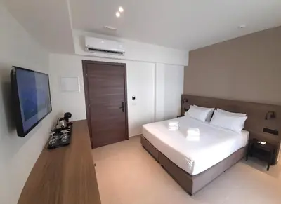 a bedroom with a bed and a flat screen tv at Elite Centre in Rhodes Town