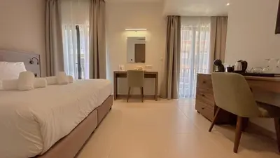 a hotel room with a bed and a desk and a desk at Elite Centre in Rhodes Town