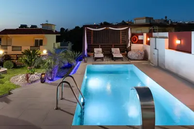 a swimming pool in the backyard of a house at Amarilia House in Koskinou