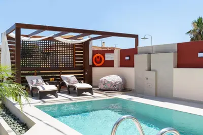 a swimming pool on the roof of a house at Amarilia House in Koskinou