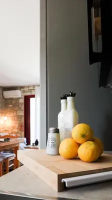 a pile of oranges on a cutting board on a kitchen counter at Tropical Garden Faliraki Rhodes in Faliraki