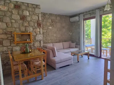 a living room with a couch and a table at Tropical Garden Faliraki Rhodes in Faliraki