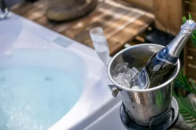 a bottle of champagne in a bucket of ice at Marco Beach Tiny House in Faliraki